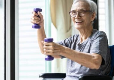 Strong asian senior woman working out with heavy dumbbells,lifting dumbbell weights for strength training,fitness elderly people doing exercise while sit in wheelchair,health care,healthy lifestyle