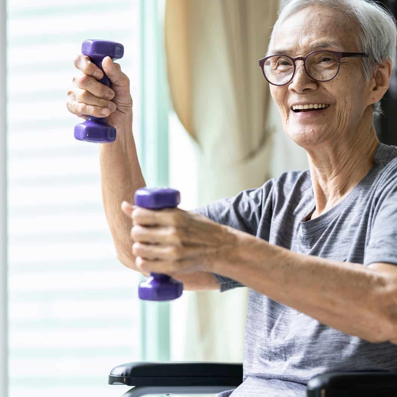 Strong asian senior woman working out with heavy dumbbells,lifting dumbbell weights for strength training,fitness elderly people doing exercise while sit in wheelchair,health care,healthy lifestyle